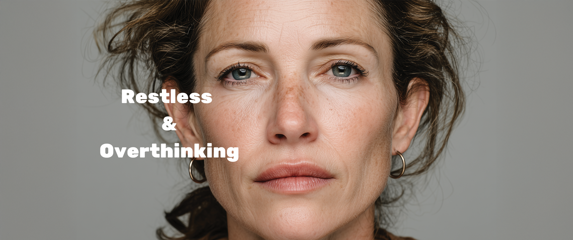 Close-up of a woman's face with text 'Restless & Overthinking' on a gray background